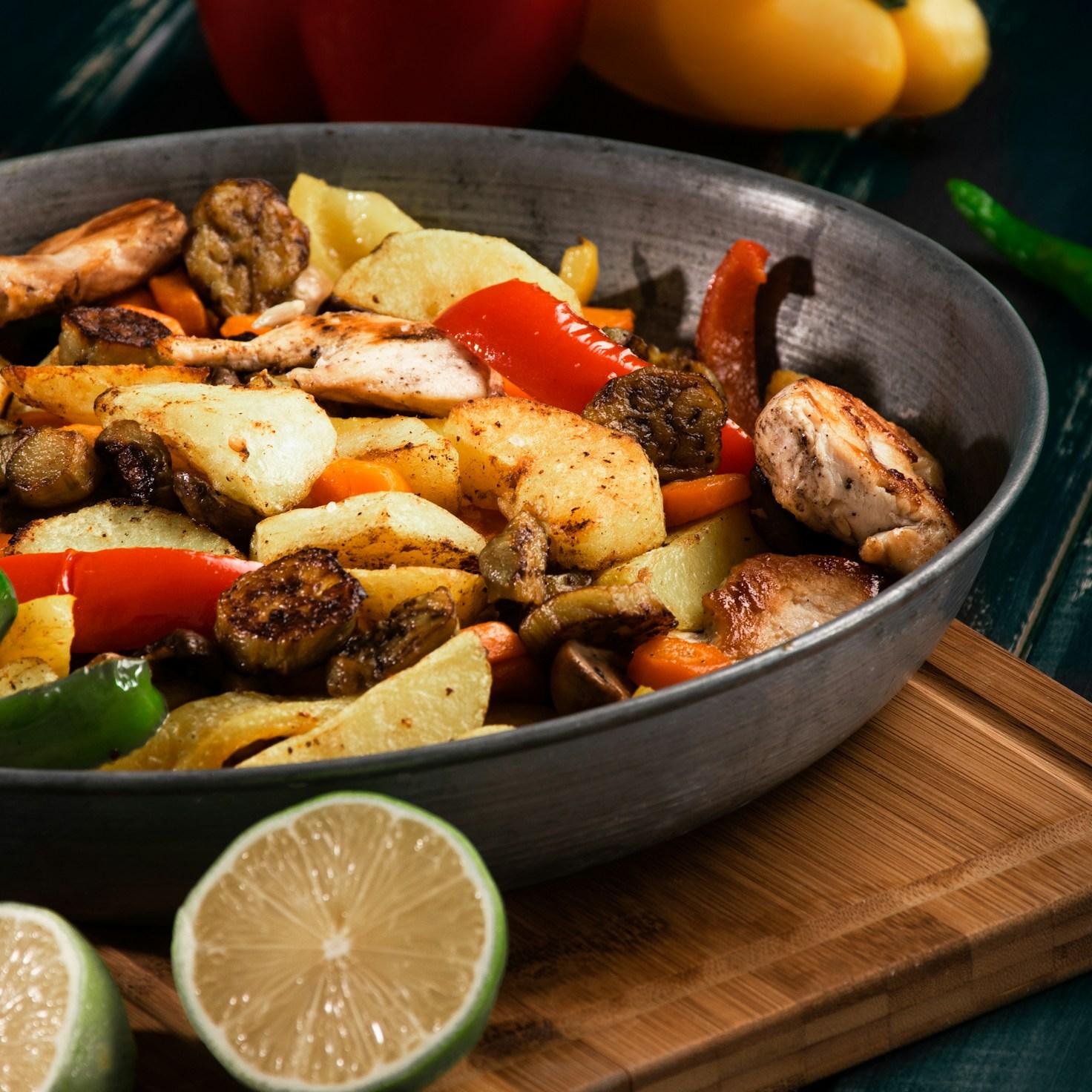 Diverse group of community members sharing a meal together, showcasing the social bonds formed through collaborative cooking